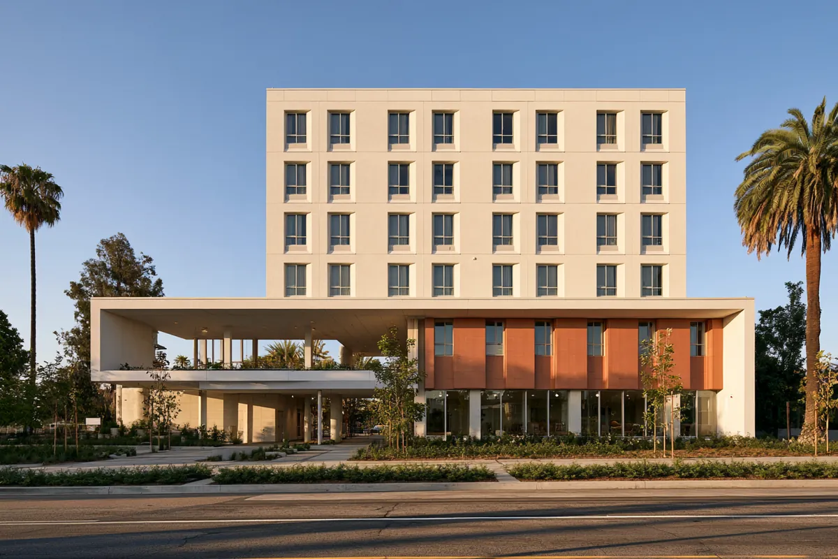 Typology study: white mid-rise apartment building over a covered ground floor.